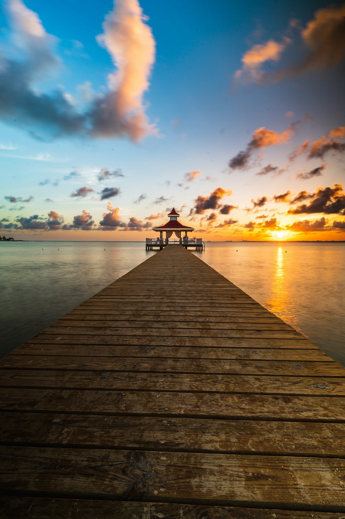 A wooden pier glowing at sunset — Bayahíbe & La Romana, Dominican Republic